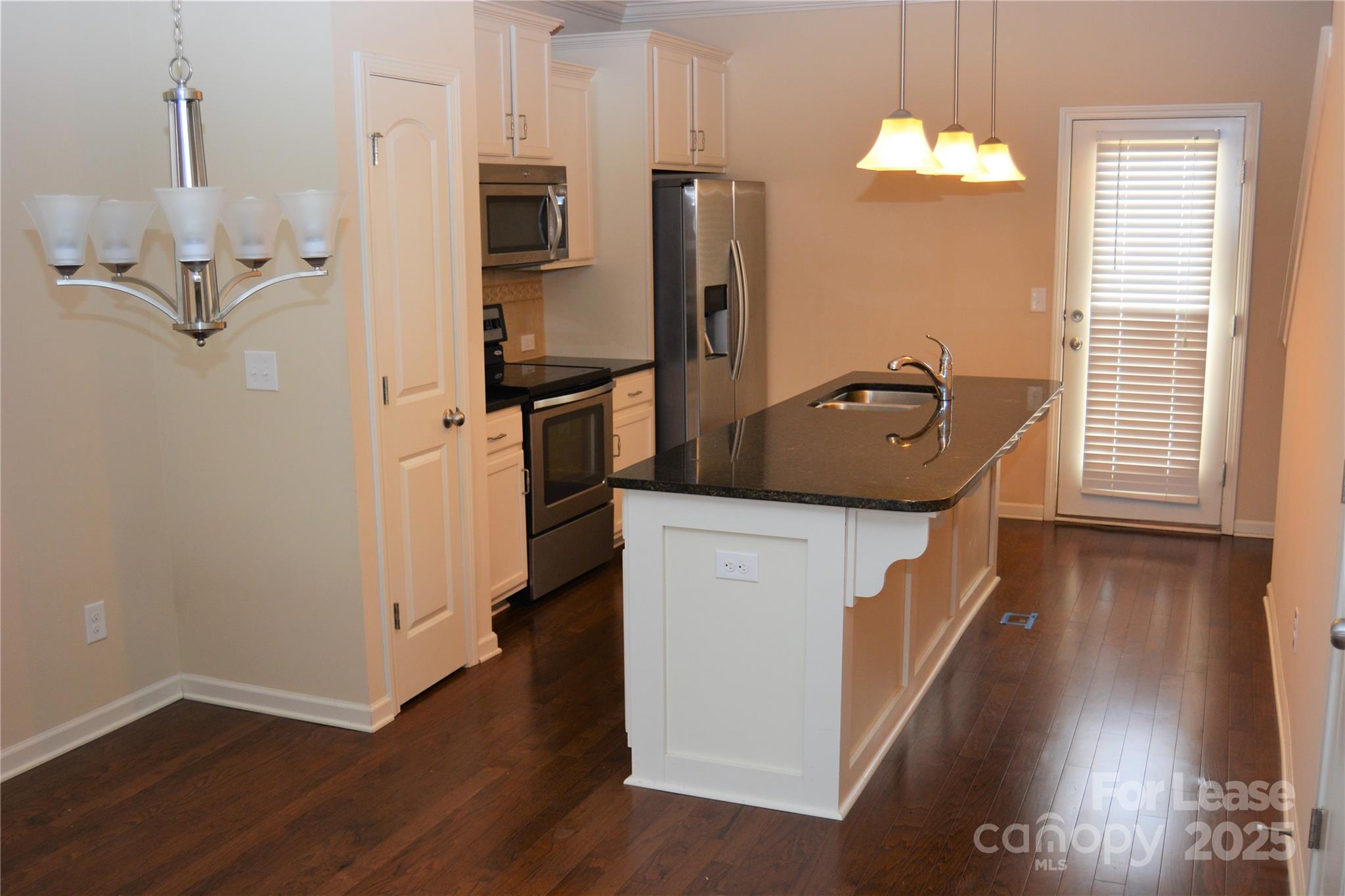 5212 Prosperity Church Road Charlotte, NC 28269 - Photo 3 of 5 a kitchen with sink refrigerator and microwave