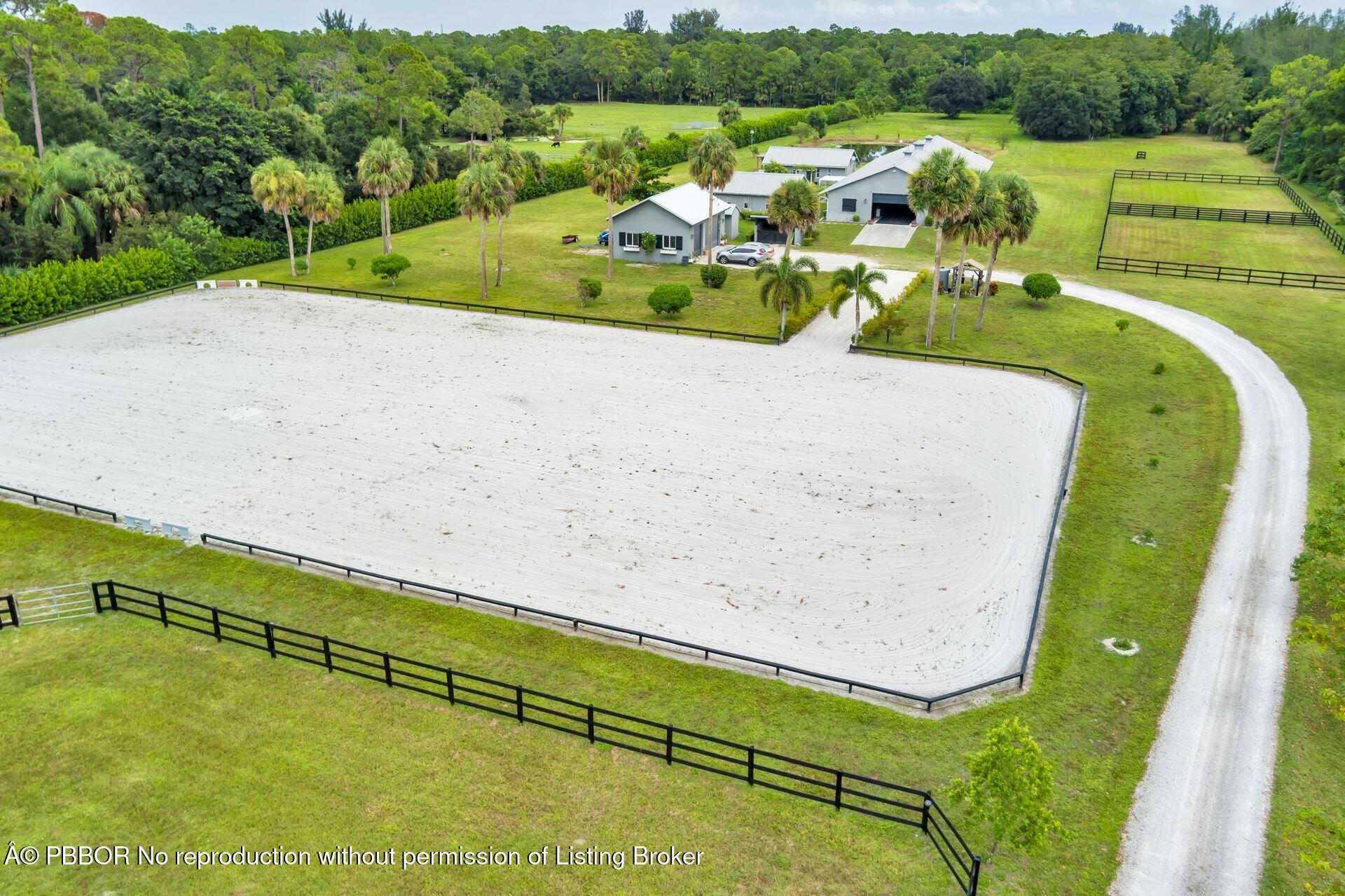 2770 E Road Loxahatchee, FL 33470 - Photo 46 of 51 a view of swimming pool with a garden and seating area