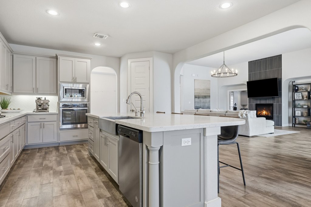 191 Tabago Court Austin, TX 78737 - Photo 40 of 40 a kitchen with kitchen island granite countertop lots of counter top space and stainless steel appliances