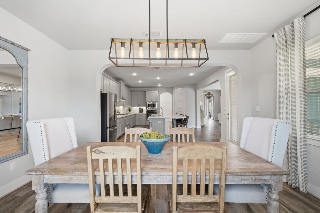 191 Tabago Court Austin, TX 78737 - Photo 13 of 40 a view of a dining room with furniture a chandelier and wooden floor