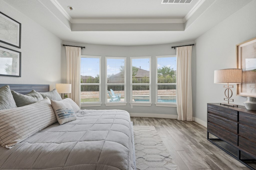 191 Tabago Court Austin, TX 78737 - Photo 16 of 40 a spacious bedroom with a large bed and a window