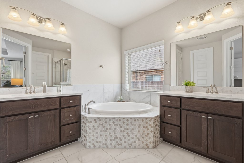 191 Tabago Court Austin, TX 78737 - Photo 18 of 40 a spacious bathroom with a tub double sink and mirror