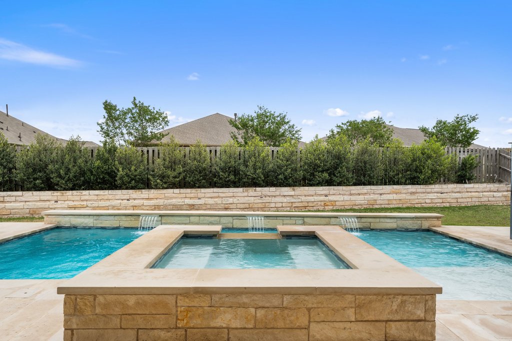 191 Tabago Court Austin, TX 78737 - Photo 33 of 40 a view of swimming pool that has lawn chairs with plants