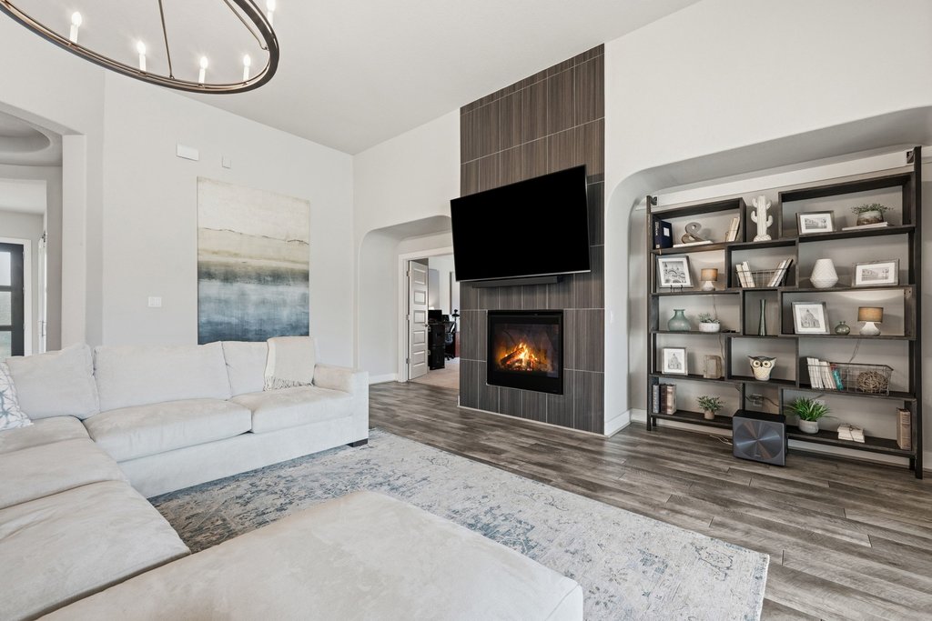 191 Tabago Court Austin, TX 78737 - Photo 5 of 40 a living room with furniture a flat screen tv and a fireplace
