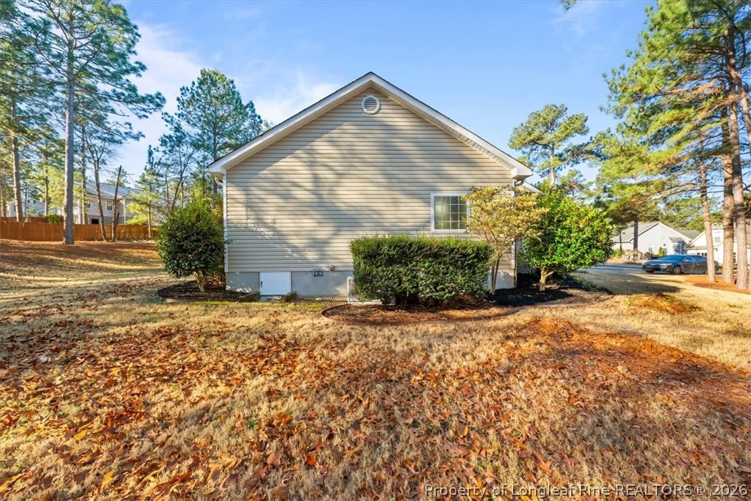 60 Spring Lake Drive Pinehurst, NC 28374 - Photo 40 of 42 a front view of a house with a yard and garage
