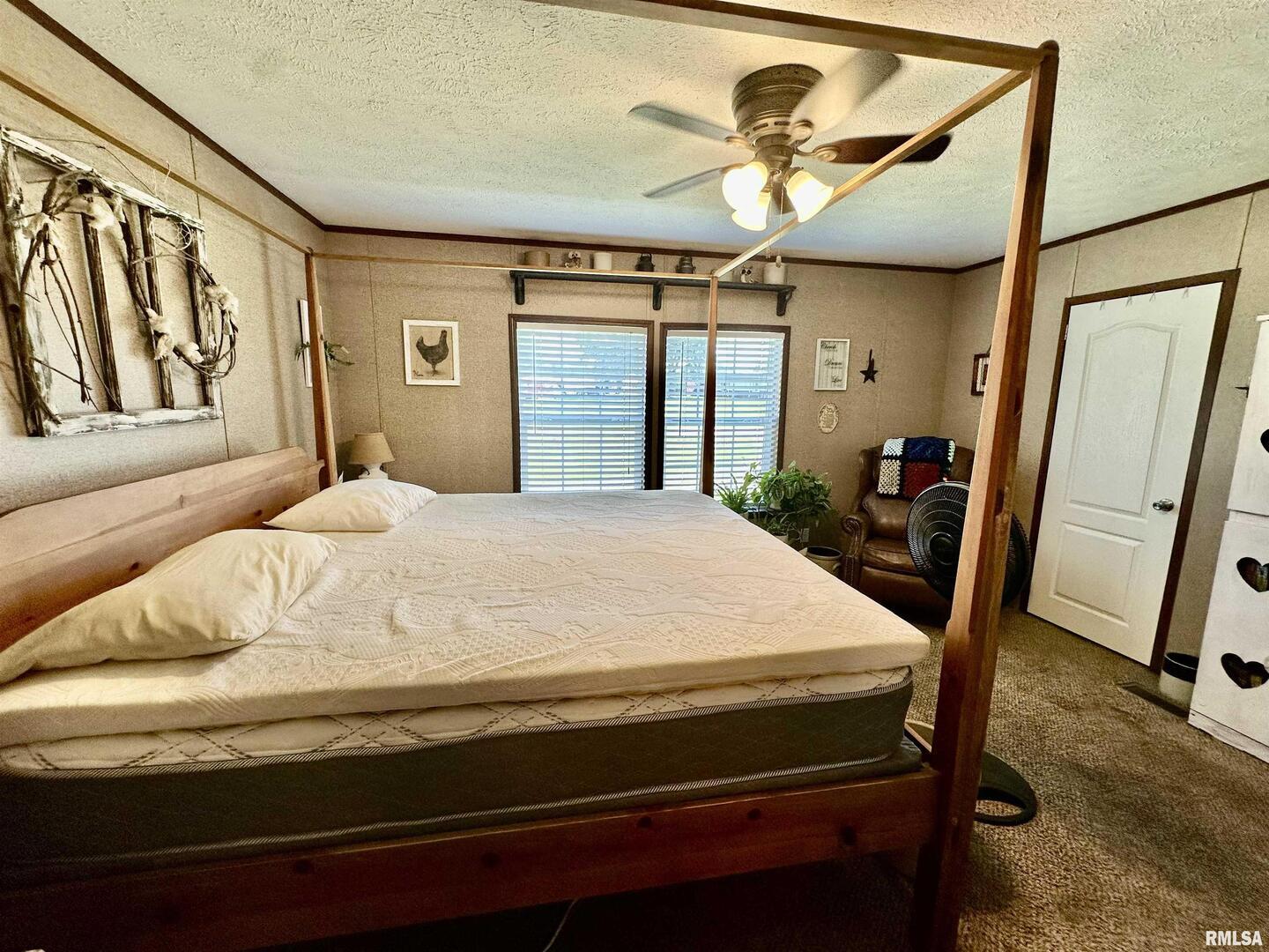 1409 West 5th Street West Frankfort, IL 62896 - Photo 16 of 56 a bedroom with a bed and a chandelier