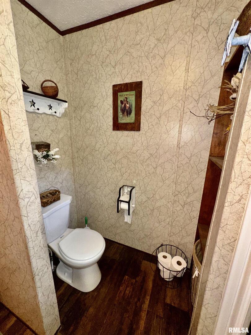 1409 West 5th Street West Frankfort, IL 62896 - Photo 19 of 56 a white toilet sitting next to a bathroom sink