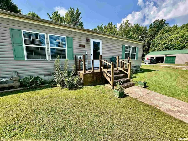 a view of a house with backyard sitting area and garden