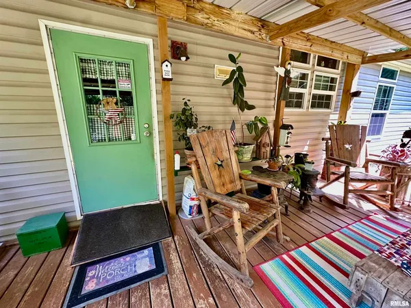 a view of a patio with table and chairs and potted plants