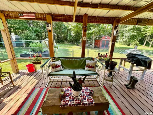 a view of a deck with wooden floor and outdoor seating