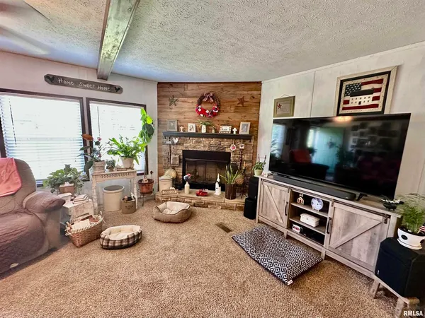 a living room with furniture a flat screen tv and a fireplace