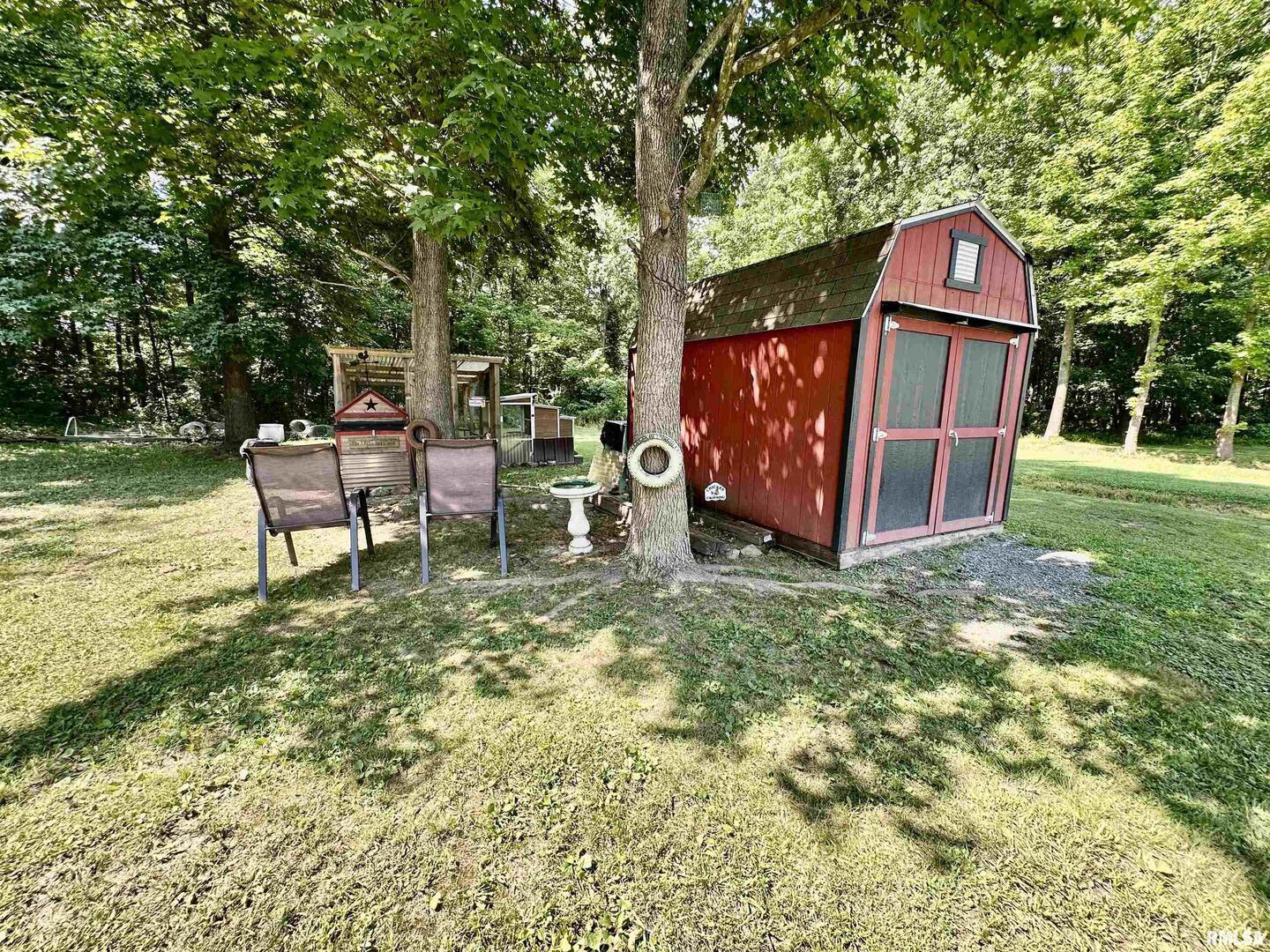 1409 West 5th Street West Frankfort, IL 62896 - Photo 52 of 56 a view of a small yard with large trees and a large tree