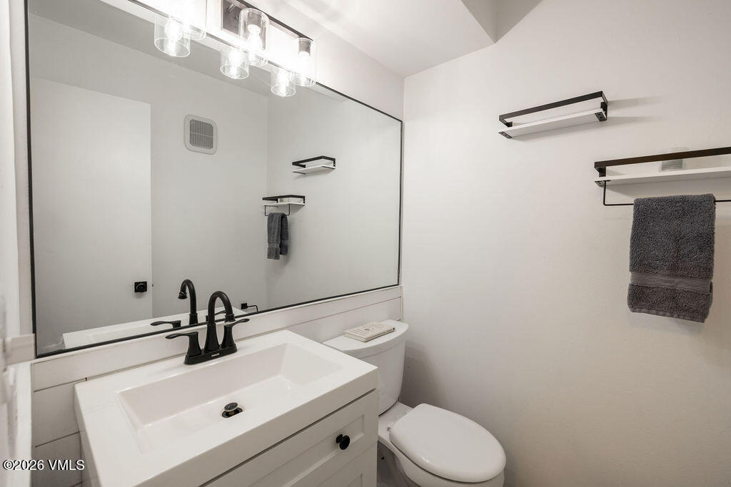 570 Homestead Drive, Unit 41 Edwards, CO 81632 - Photo 9 of 28 a bathroom with a sink mirror vanity and toilet