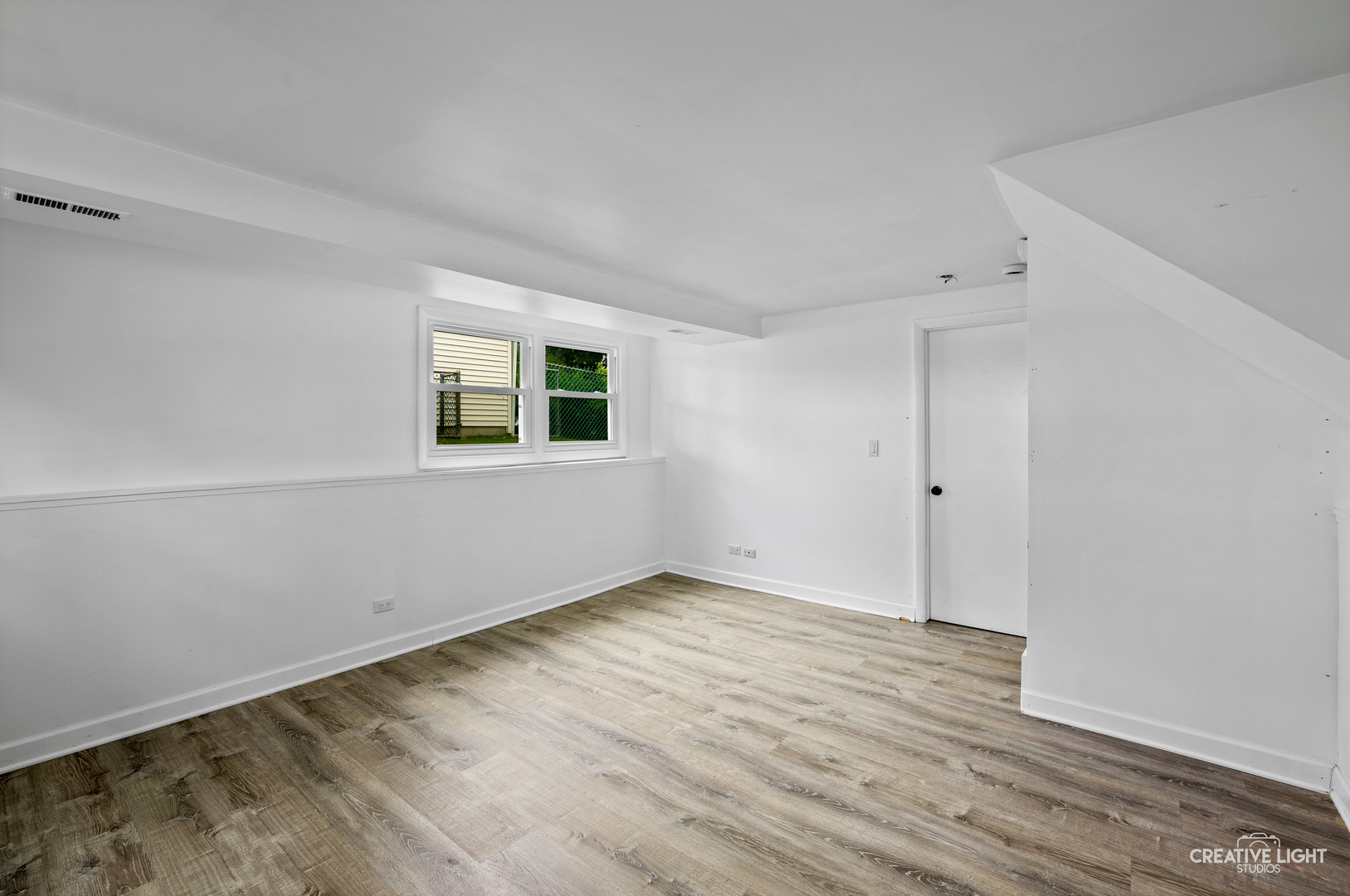 110 Delaware Drive Bolingbrook, IL 60440 - Photo 14 of 15 an empty room with wooden floor and windows