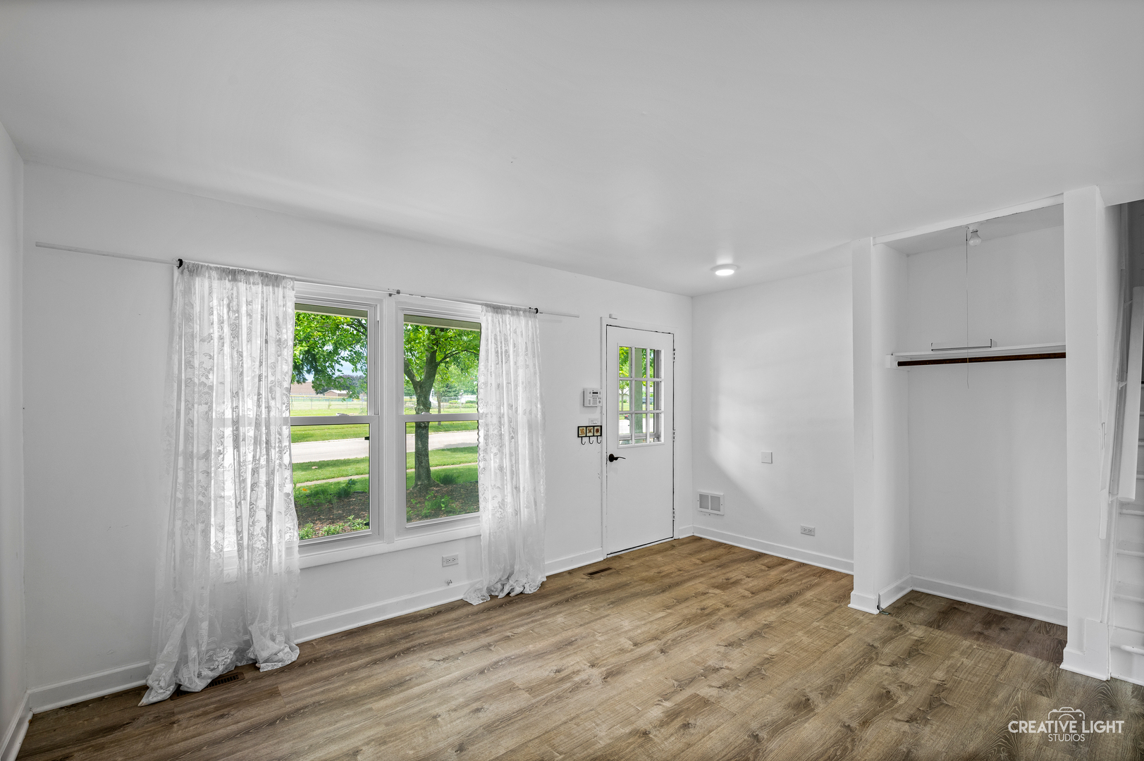 110 Delaware Drive Bolingbrook, IL 60440 - Photo 2 of 15 a view of an empty room with wooden floor and a window