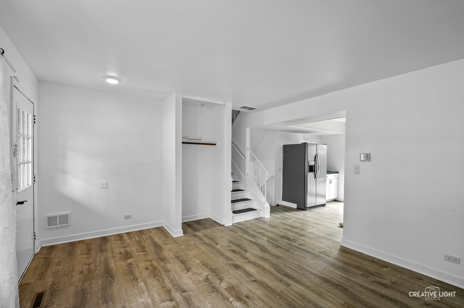 110 Delaware Drive Bolingbrook, IL 60440 - Photo 3 of 15 a view of a room with wooden floor and a ceiling fan