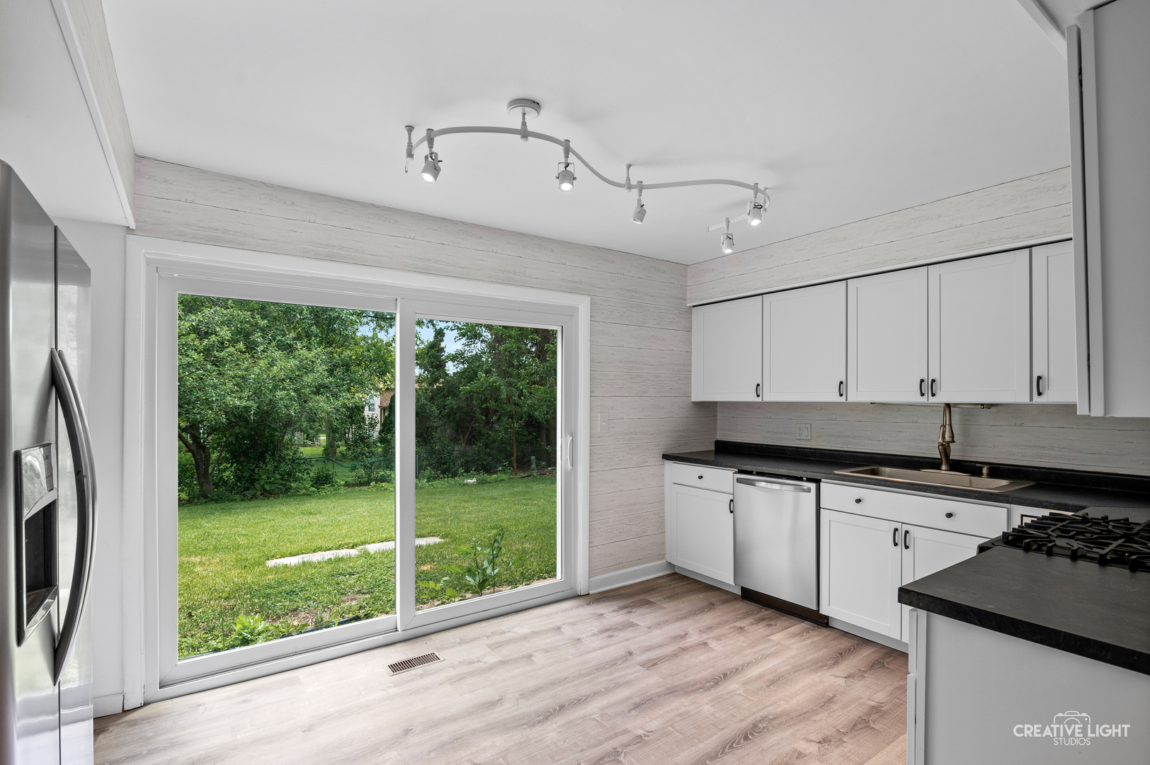 110 Delaware Drive Bolingbrook, IL 60440 - Photo 4 of 15 a kitchen with stainless steel appliances granite countertop a sink a stove and a refrigerator