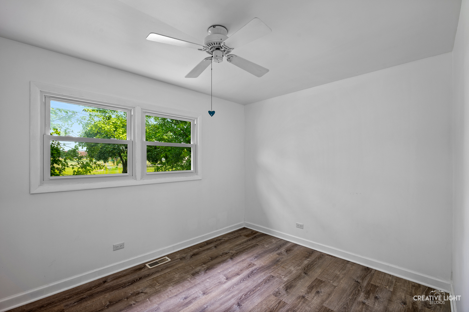 110 Delaware Drive Bolingbrook, IL 60440 - Photo 6 of 15 an empty room with a window and wooden floor
