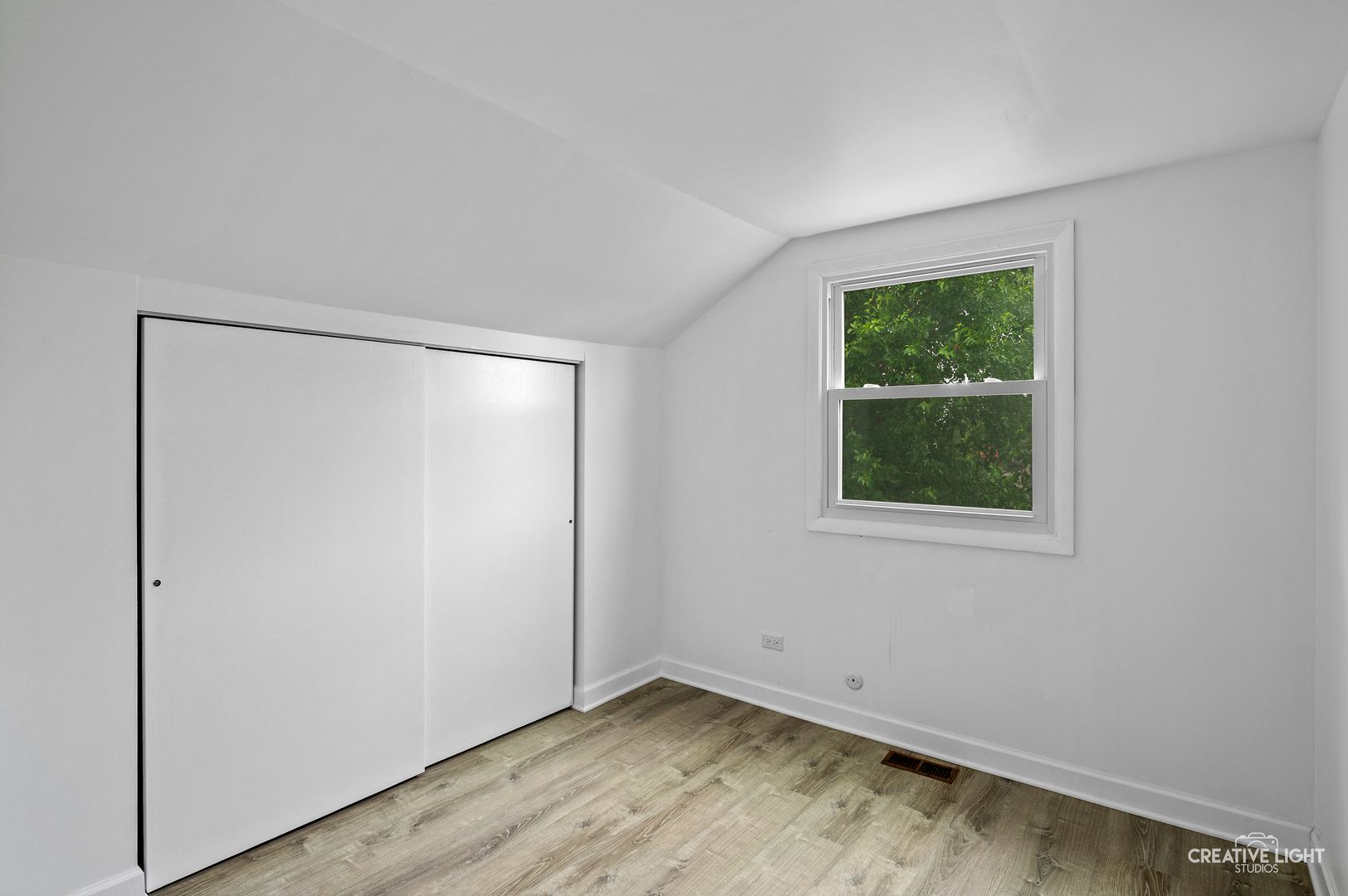 110 Delaware Drive Bolingbrook, IL 60440 - Photo 10 of 15 a view of an empty room with wooden floor and a window