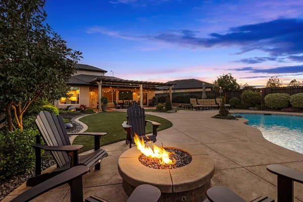 a patio with a table and chairs and a barbeque