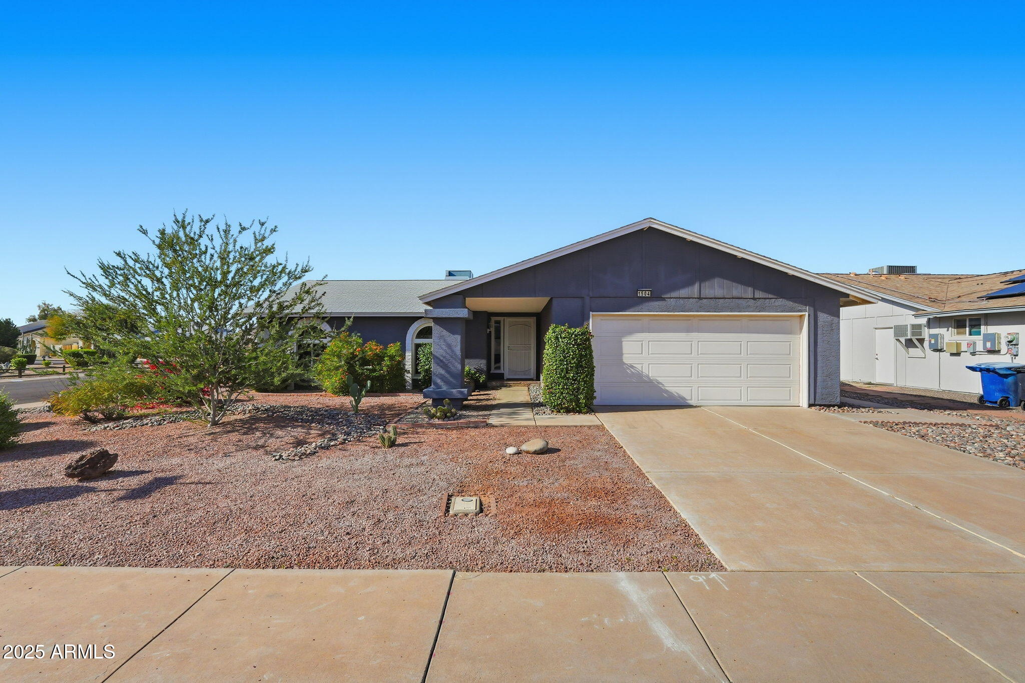 1504 North Iowa Street Chandler, AZ 85225 - Photo 1 of 34 a front view of a house with a yard and garage