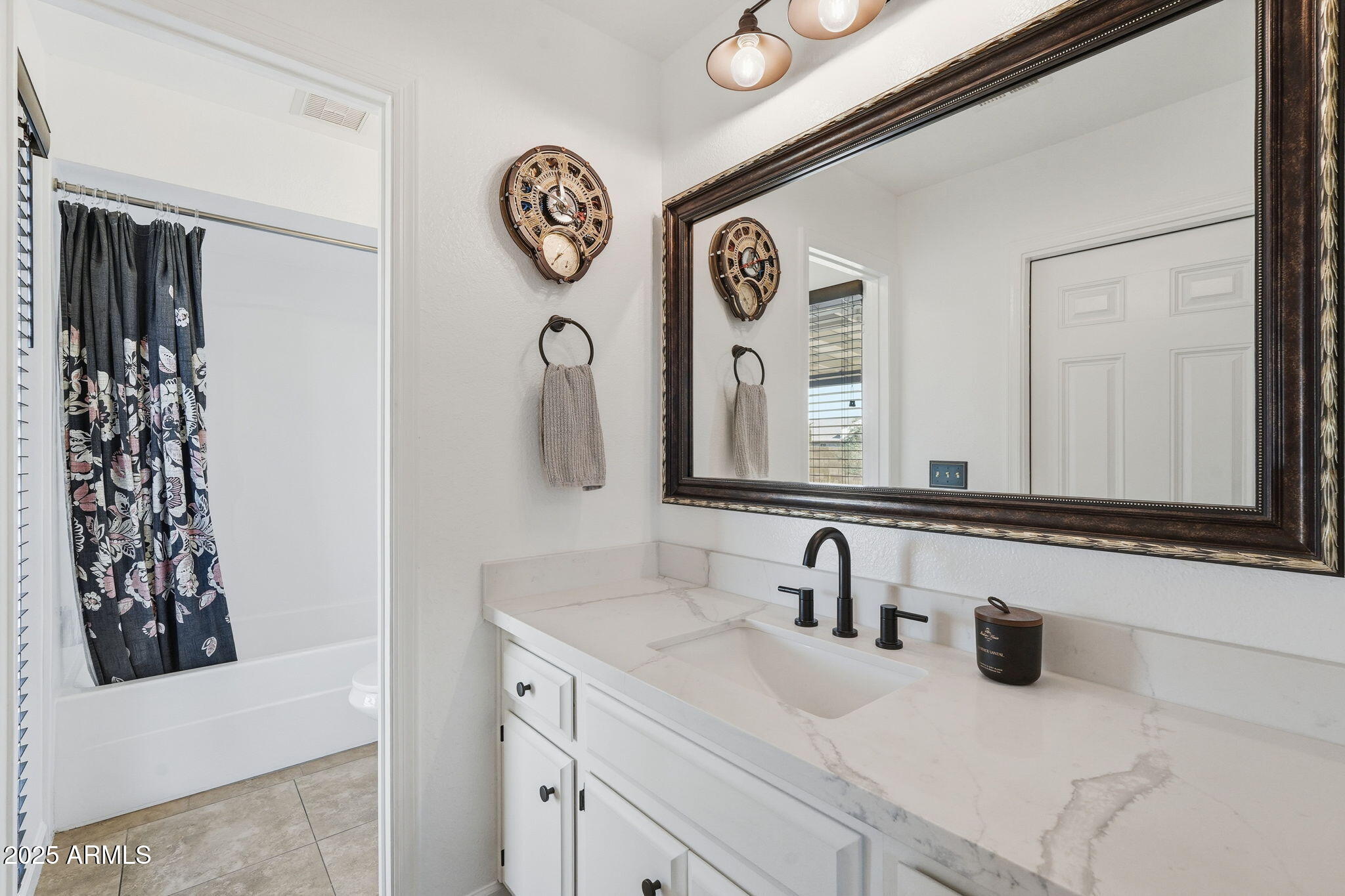 1504 North Iowa Street Chandler, AZ 85225 - Photo 21 of 34 a bathroom with a sink and a mirror