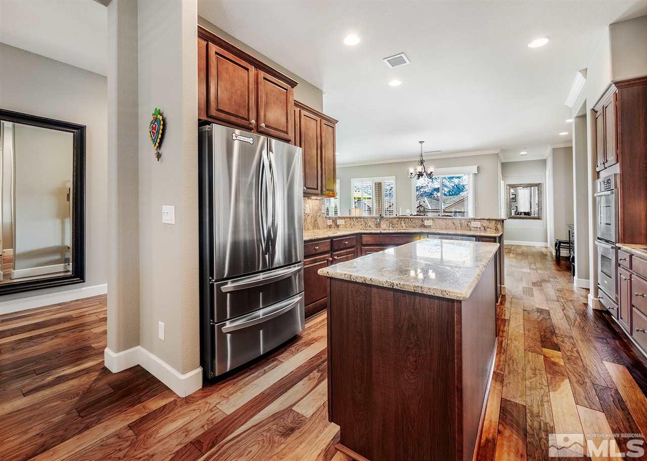 9360 Chalkstone Way Reno, NV 89523 - Photo 11 of 26 a kitchen with stainless steel appliances granite countertop a refrigerator and a sink