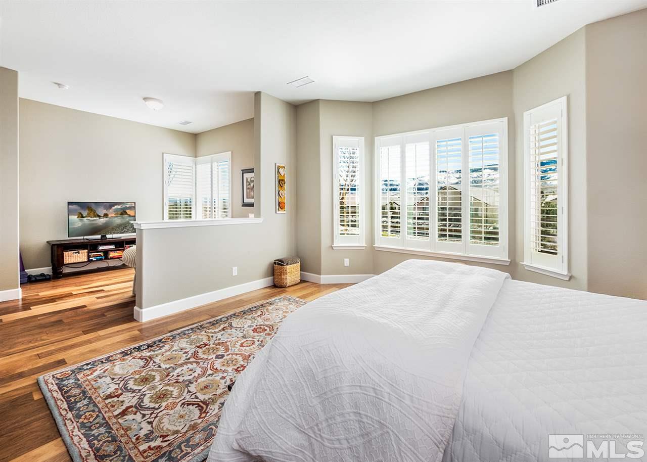 9360 Chalkstone Way Reno, NV 89523 - Photo 15 of 26 a bedroom with a bed and a large window