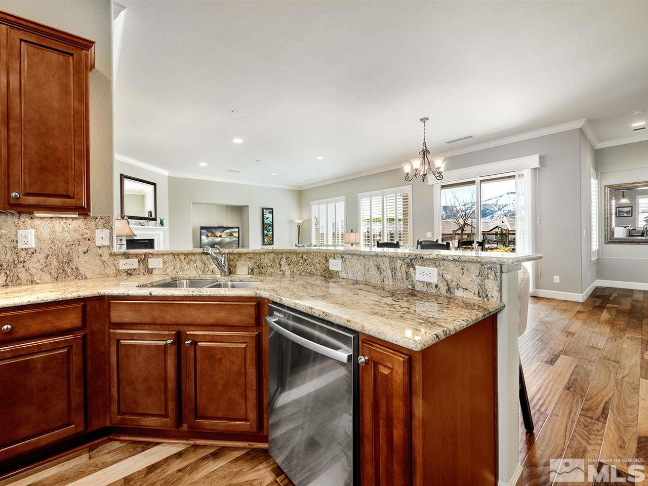 9360 Chalkstone Way Reno, NV 89523 - Photo 8 of 26 a kitchen with center island and stainless steel appliances