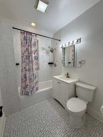 a bathroom with a toilet a sink and bathtub