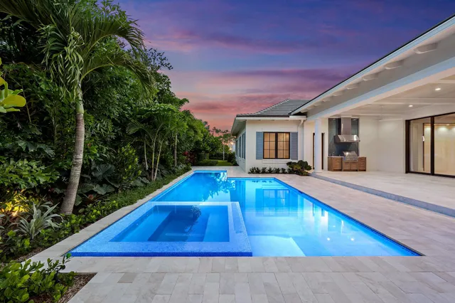a view of a house with swimming pool and sitting area