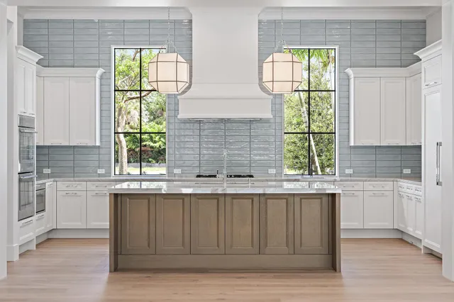 a kitchen with a sink cabinets and window