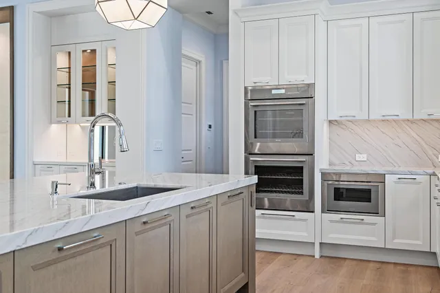 a kitchen with stainless steel appliances granite countertop a stove and a microwave