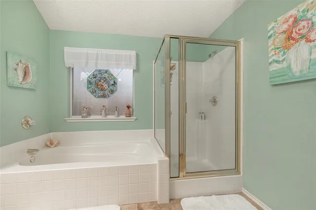 a bathroom with bathtub and shower