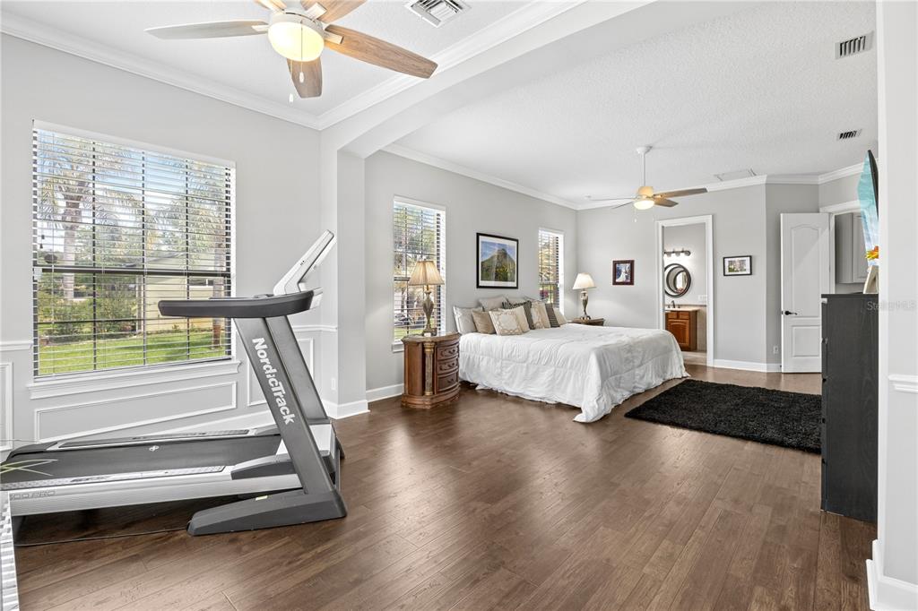 11325 Preston Cove Road Clermont, FL 34711 - Photo 19 of 58 a bedroom with a bed and wooden floor