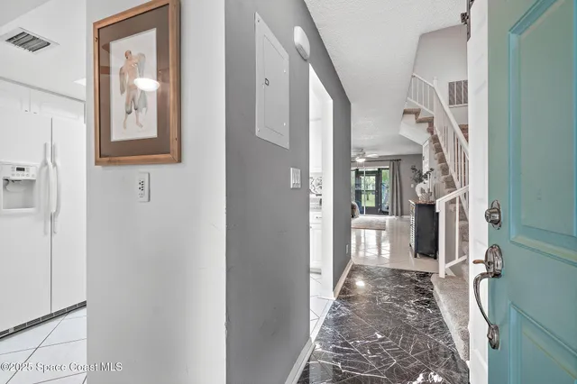 an aerial view of residential houses with outdoor space and street view