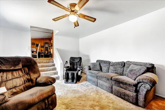 a living room with furniture and a chandelier