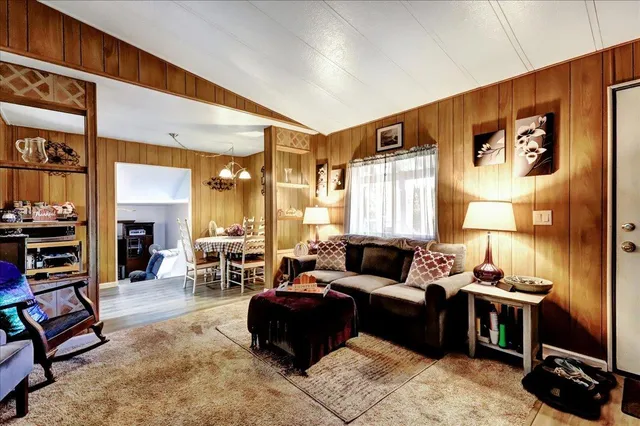 a living room with furniture fireplace and a large window