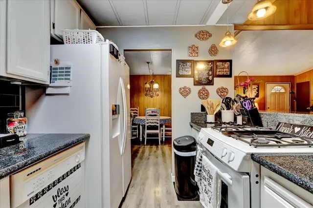 a kitchen with stainless steel appliances granite countertop a stove and a sink