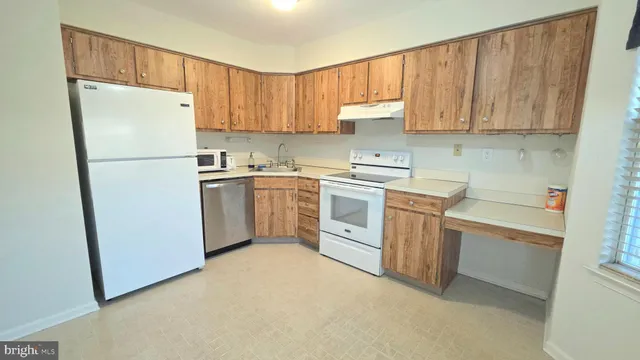 a kitchen with a white cabinets and white appliances