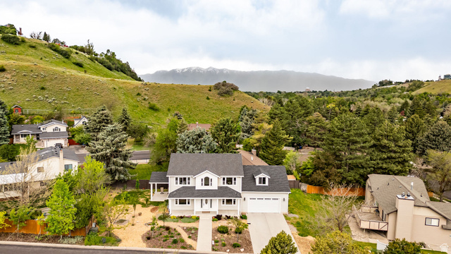 1552 Sumac Drive Logan, UT 84321 - Photo 69 of 72 Contemporary two-story residence featuring a light-toned exterior, dark shingle roof, and an attached two-car garage