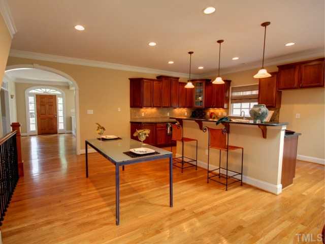 206 Avon Drive Raleigh, NC 27608 - Photo 12 of 12 Through an Arched Entryway, you'll find the Heart of the Home: an Open Floorplan of Kitchen Family Room.