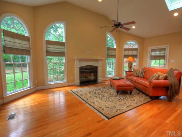 206 Avon Drive Raleigh, NC 27608 - Photo 6 of 12 The Family Room features Cathedral Ceiling and a Gas-Log Fireplace with Granite Hearth surrounded by Palladian Windows overlooking the Wooded Backyard.