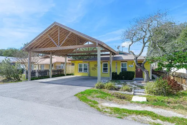 a front view of a house with a yard table and chairs