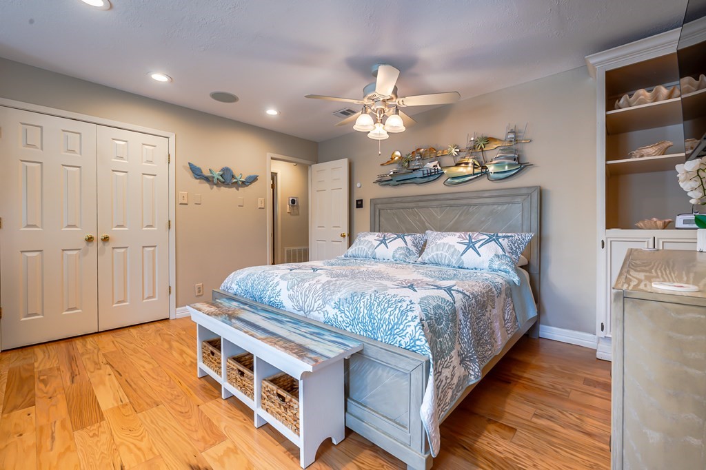 9 Sandra Drive Fulton, TX 78382 - Photo 21 of 35 a spacious bedroom with a bed and a chandelier