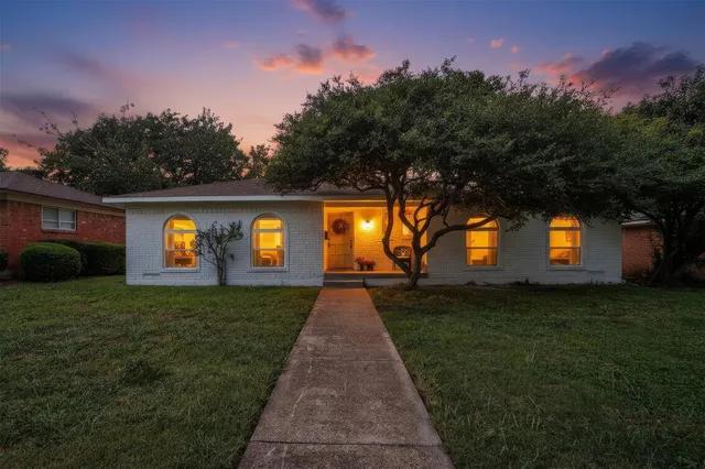 a view of yellow house with a big yard