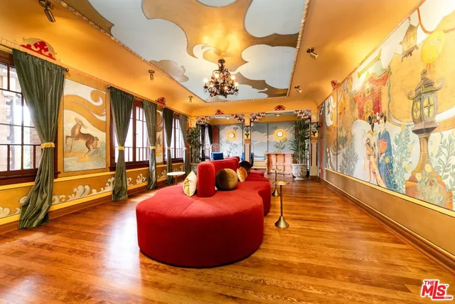 a bedroom with a large bed and windows