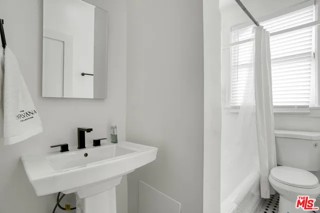 a living room with furniture a rug and a window