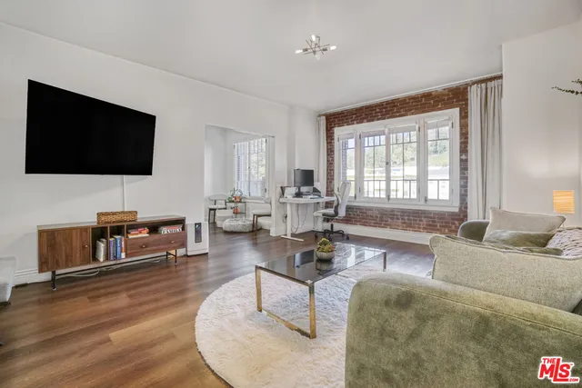 a kitchen with granite countertop a sink a stove and refrigerator