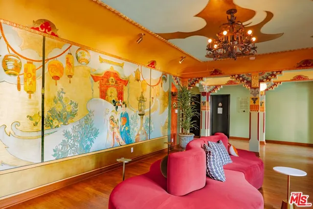 a large bedroom with a bed and wooden floor